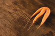 Ugly carrot on a wooden background. Funny, unnormal vegetable or food waste concept. Horizontal orientation