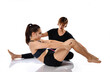 © FAB.1 - Fitness trainer helps a young girl to do exercises on a white background.