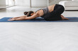 © Arsenii - Young sporty attractive woman practicing yoga at home, doing Child exercise, Balasana pose, stretching, relaxing, wearing sportswear. Copy space. Well being, fitness and healthy lifestyle concept