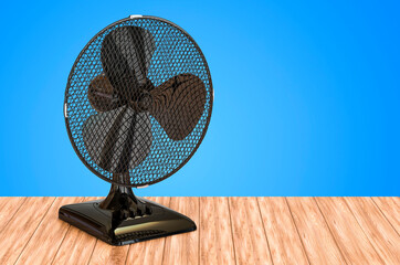 Poster - table fan on the wooden table. 3d rendering