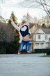 © Jakob Lagerstedt/Stocksy - Cute young girl in a love sweater jumping with joy