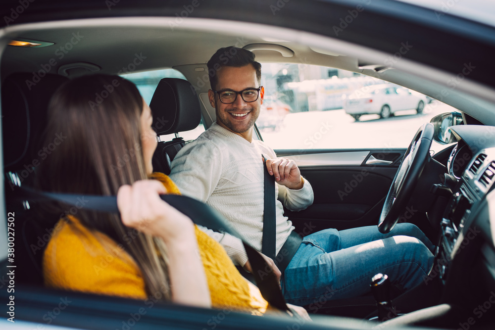 Husband and his pregnant wife driving in car. Stock Photo | Adobe Stock