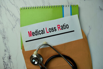 Medical Loss Ratio text on document above brown envelope. Healthcare or medical concept