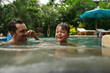 © Rob and Julia Campbell/Stocksy - Dad and son having fun together in outdoor pool