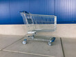 © Rialto Images/Stocksy - Shopping cart against blue wall