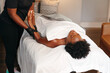 © Gerald R Carter Jr/Creative Flame - Black woman getting relaxing massage from black masseuse