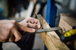 © BORIS JOVANOVIC/Stocksy - Close up of a man thinning out wire with a rasp
