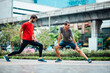© Marko/Stocksy - Two friends stretching after run outdoor