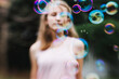 © Jacqui Miller/Stocksy - Young girl with bubbles