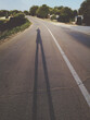 © HEX./Stocksy - Man Casts Long Shadow on the Street