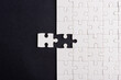 © sorapop - Top view flat lay of paper plain white jigsaw puzzle game texture last pieces for solve and place, studio shot on a black background, quiz calculation concept