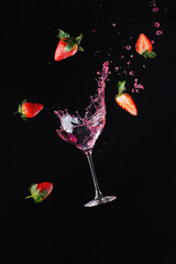 Explosion of freshness with a cool glass of wine. Black background