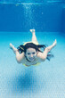 © Michela Ravasio/Stocksy - Underwater view of woman diving