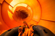 © blurMEDIA/Stocksy - Family Speeding Down Giant Water Slide at Theme Park