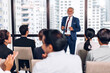 © Art_Photo - Businessman standing in front of group of people in consulting meeting conference seminar at hall or seminar room.presentation and coaching concept