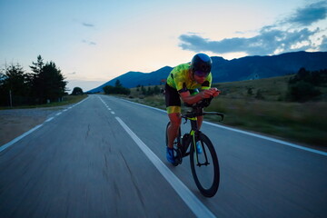 Poster - triathlon athlete riding bike at night