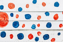 Painted Red And Blue Polka Dots On A Wooden Surface