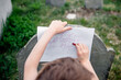 © Cara Dolan/Stocksy - Child does a gravestone rubbing in an old cemetery