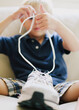 © Kelly Knox/Stocksy - young child learning to tie shoelaces