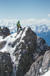 © Akela - from alp to alp/Stocksy - male mountaineer on top of a summit in the austrian alps