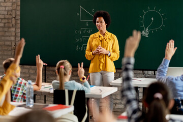 Black elementary school teacher holding a class in the classroom.