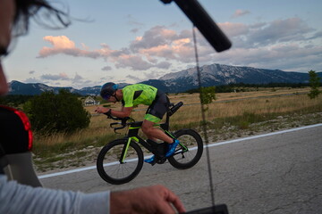 Poster - cinematographer taking action shot of triathlon bike athlete