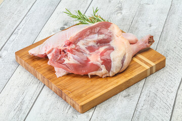 Raw duck leg served rosemary