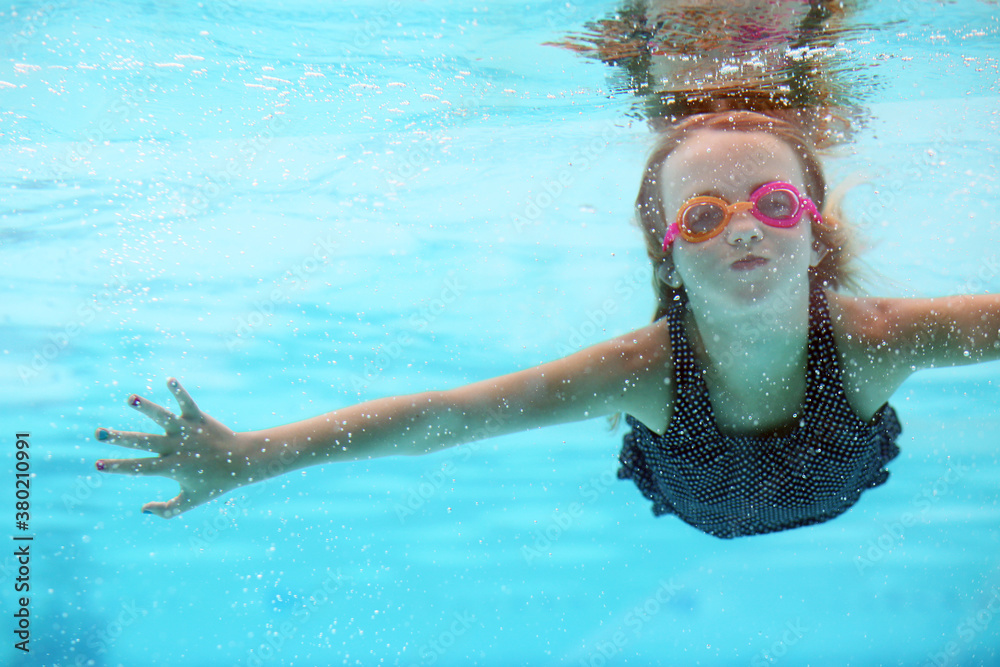 Girl Swimming Underwater Wearing Goggles Stock Photo | Adobe Stock
