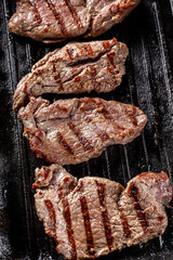 Wall Mural - American cuisine. Fried pork in a cast iron skillet with stripes.