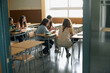 © MIQUEL LLONCH/Stocksy - Group of teenager girls sitting inside a class