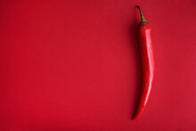 Food Background Flat Lay. Red Hot Chili Pepper On Red Background From Above. Minimal Creative Still Life With Mexican Spicy Paprika.