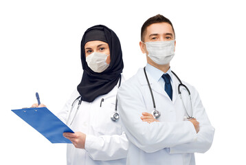 Wall Mural - medicine, healthcare and people concept - doctors wearing face protective medical masks for protection from virus disease with clipboard and stethoscope over white background