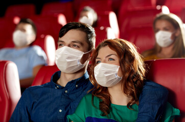 Sticker - cinema, entertainment and pandemic concept - couple wearing face protective medical masks for protection from virus disease watching movie in theater