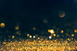 Luxury abstract glitter bokeh background. New year and christmas holiday party design. Golden star dust light sparkling on dark backdrop.