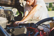 © Tana Teel Photography/Stocksy - Young man working on motor of an old pickup