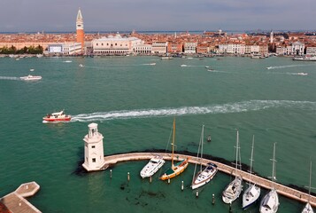 Aerial panorama of Giudecca Canal viewed from San Giorgio Maggiore Church in Venice, with the Campanile & Doge Palace in St Mark's Square ( Piazza San Marco ) opposite the waterway of busy traffic