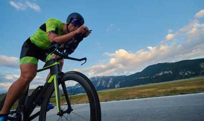 Wall Mural - triathlon athlete riding bike