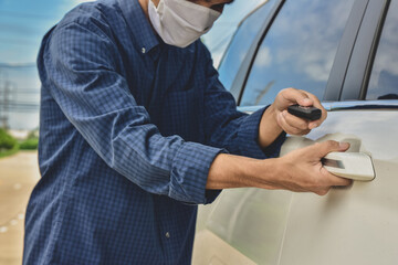 Wall Mural - Man wearing medical mask are opening car door