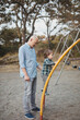 © Rob and Julia Campbell/Stocksy - Asian dad spending time with son outside at playground