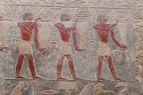 Painted bas relief figures showing daily life in ancient Egypt