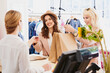 © Aila Images/Stocksy - Friends Shopping with credit card in fashion boutique