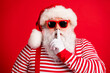 © deagreez - Close-up portrait of his he nice handsome mysterious white-haired Santa wearing sunglasses showing shh sign silence silent mute isolated over bright vivid shine vibrant red color background