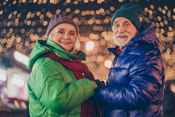 Sticker - Photo of dream two charming retired pensioner couple woman man visit town center x-mas christmas spirit fair hold hand under lights wear season coat hat scarf