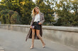 © Svetlana Sokolova - Fashion full length image of elegant  blond  woman in stylish luxury beige leather  coat and hight heels, walking  outdoor. Autumn fashion look.