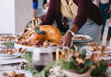 Woman Carries Thanksgiving Turkey On A Platter