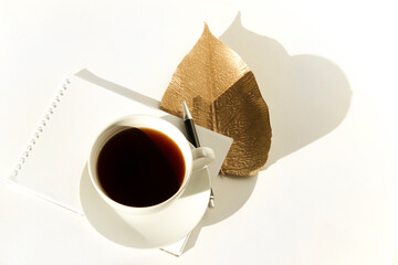 coffee and autumn leaf on a white background . the concept of autumn coziness