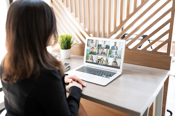 Wall Mural - Business woman having a video conference on her laptop