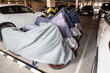 Motorbikes saving and keeping under covers for a winter season in warm parking area on one vehicle place