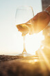 © Lumina/Stocksy - Woman's Hand Takes a Glass of White Wine