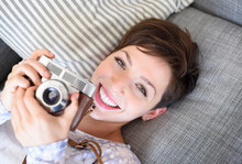 Portrait Of Young Woman Holding Old Fashioned Camera